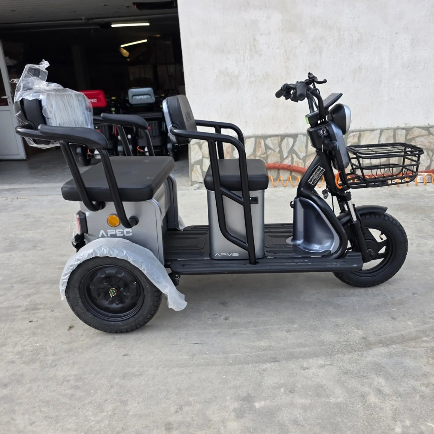 Vedere laterală în exterior pentru tricicleta electrică Grande gri, ideală pentru pasageri.