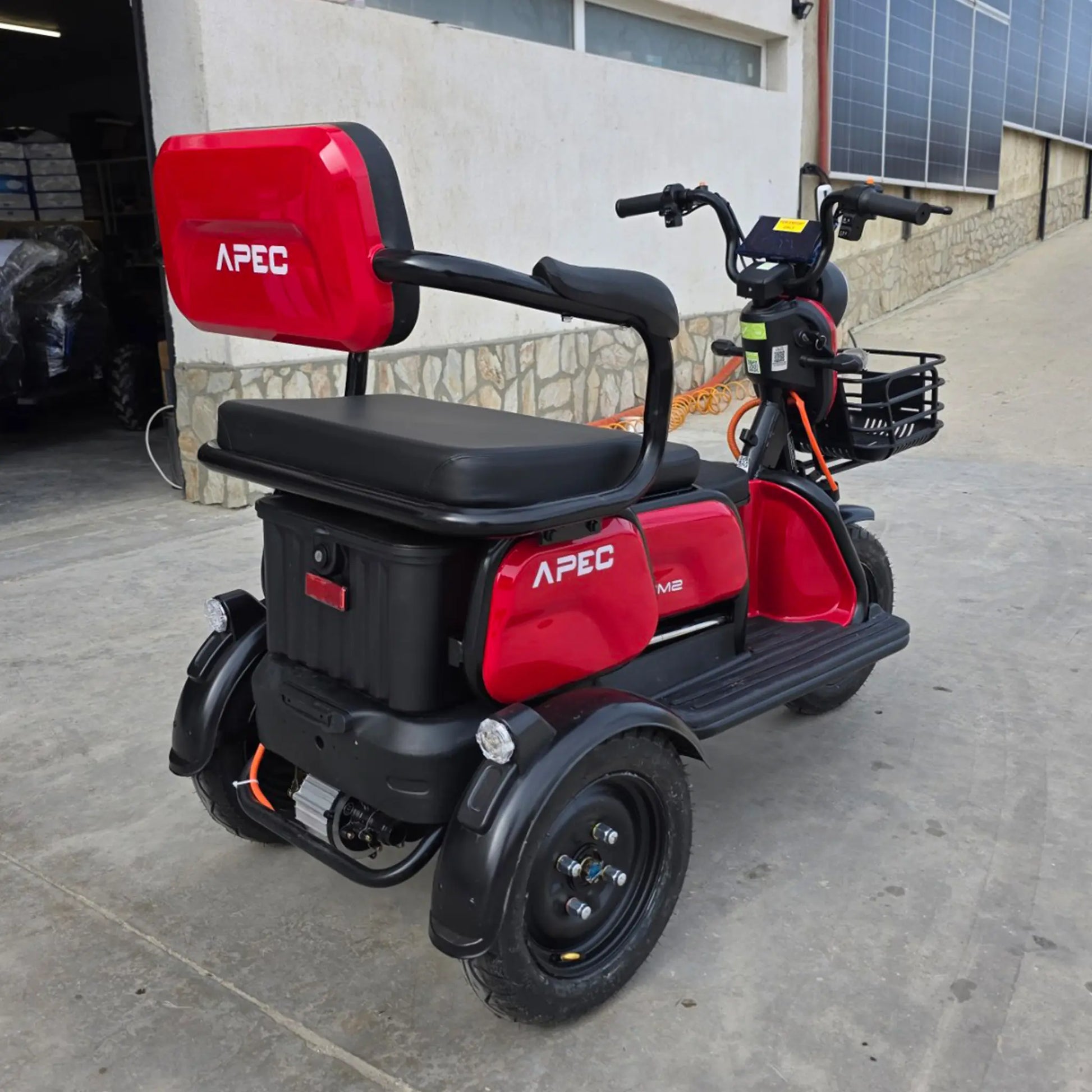 Vedere din spate dreapta tricicletă electrică roșie, model sport cu spațiu de depozitare și 3 locuri.
